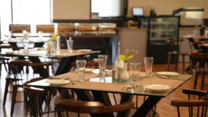 Restaurant workplace environment showing empty tables and operational setting related to sexual harassment risk and reporting oversight