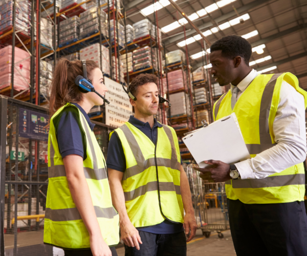warehouse workers discussing incident management solutions